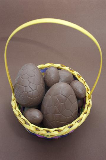 easter_chocolates_basket.jpg - Overhead view of unwrapped chocolate Easter eggs of varying sizes in a basket