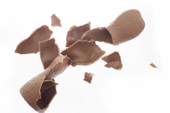 broken_chocolate_bunny.jpg - Close up of broken chocolate easter bunny pieces isolated on white background