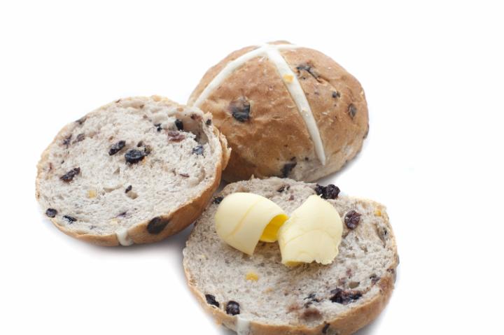sliced_buttered_easter_buns.jpg - Sliced and buttered Easter buns over white background with slight dark set down shadow
