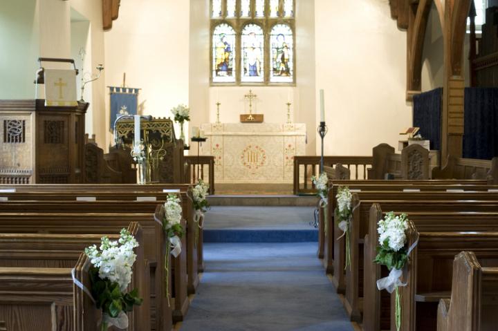 spring_time_church.jpg - Springtime church aisle with wooden pews decorated with white spring blossom in a small country church