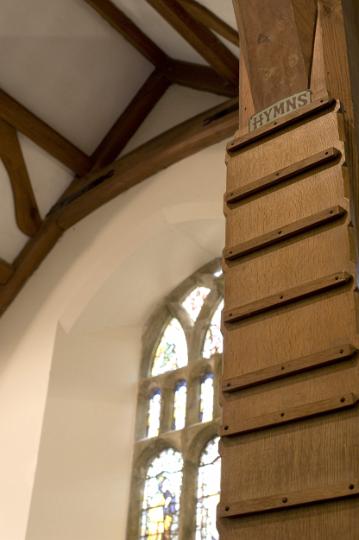 wooden_hymn_board.jpg - Empty wooden hymn board hanging in the interior of a small country church