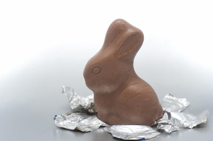 easter_rabbit.jpg - Milk chocolate bunny Easter egg unwrapped and sitting on its foil wrapper